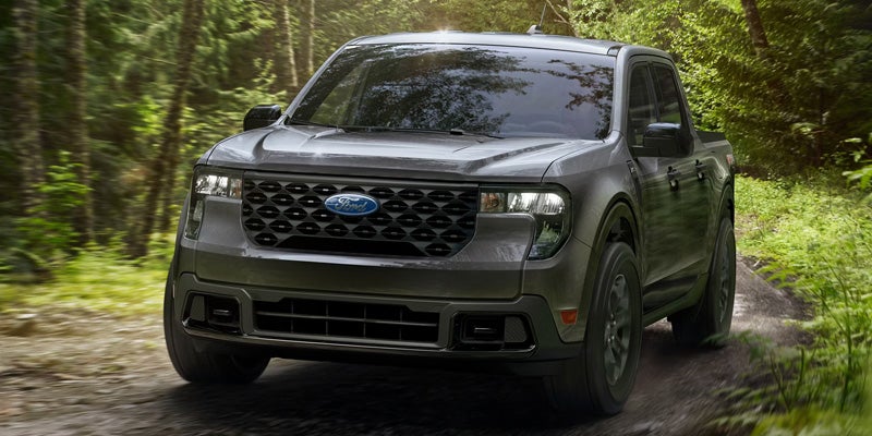 2026 Ford Maverick driving on a forest back road