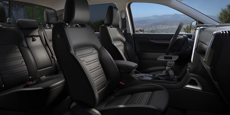 Dashboard, front seats, and center display inside a 2026 Ford Ranger