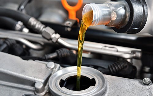 Engine oil being poured during Ford oil change service